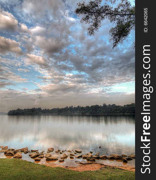 Cloudfilled skies in the morning over a lake. Cloudfilled skies in the morning over a lake