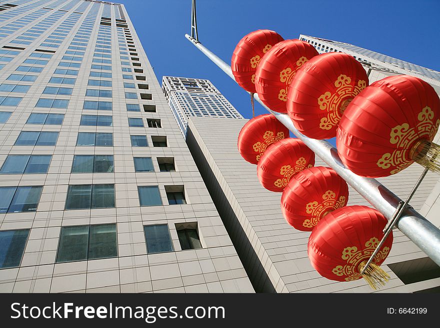 Red lantern and  skyscraper with blue sky in Beijing CBD(Central Business District),China. tradition   VS modern. Red lantern and  skyscraper with blue sky in Beijing CBD(Central Business District),China. tradition   VS modern