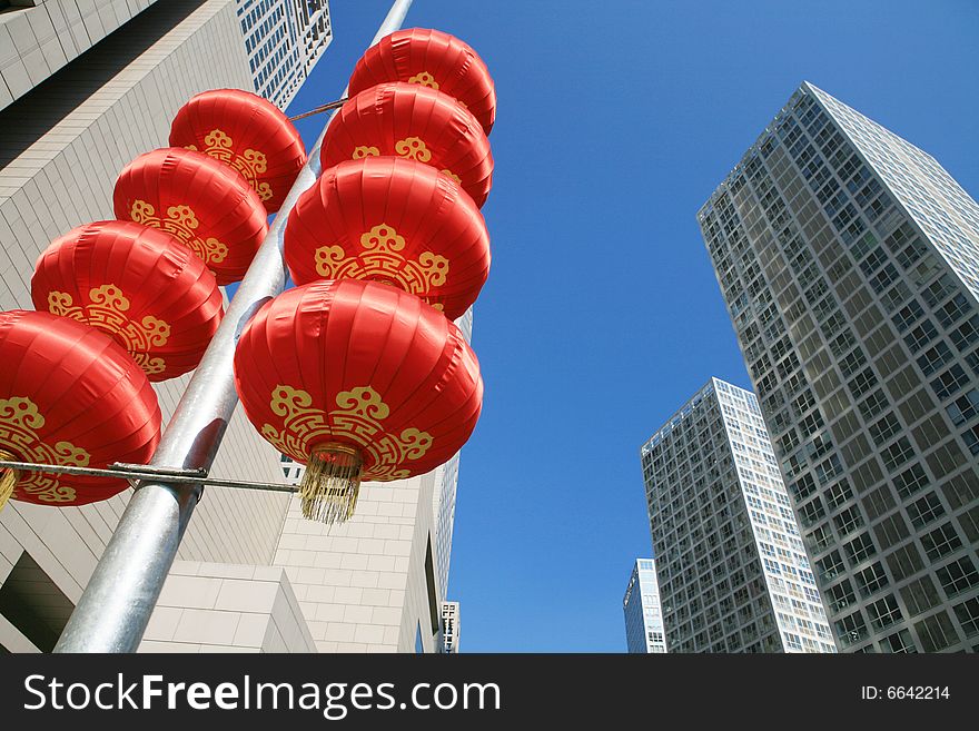 Red lantern and  skyscraper with blue sky in Beijing CBD(Central Business District),China. tradition   VS modern. Red lantern and  skyscraper with blue sky in Beijing CBD(Central Business District),China. tradition   VS modern