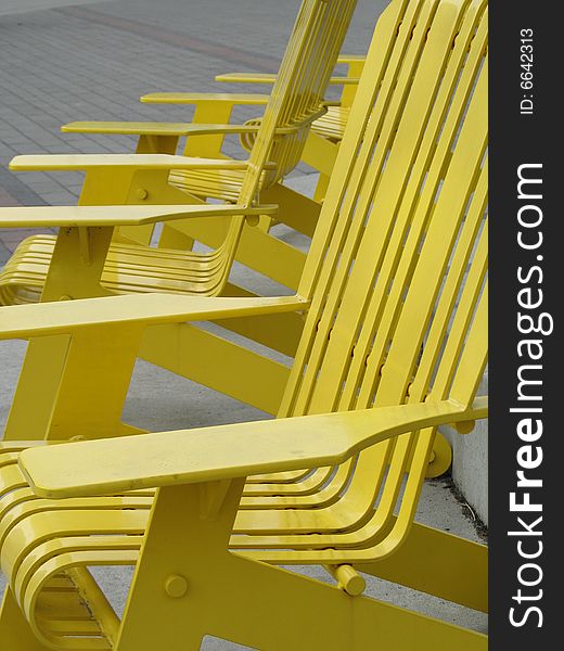 Yellow metal outdoor chair in a row
