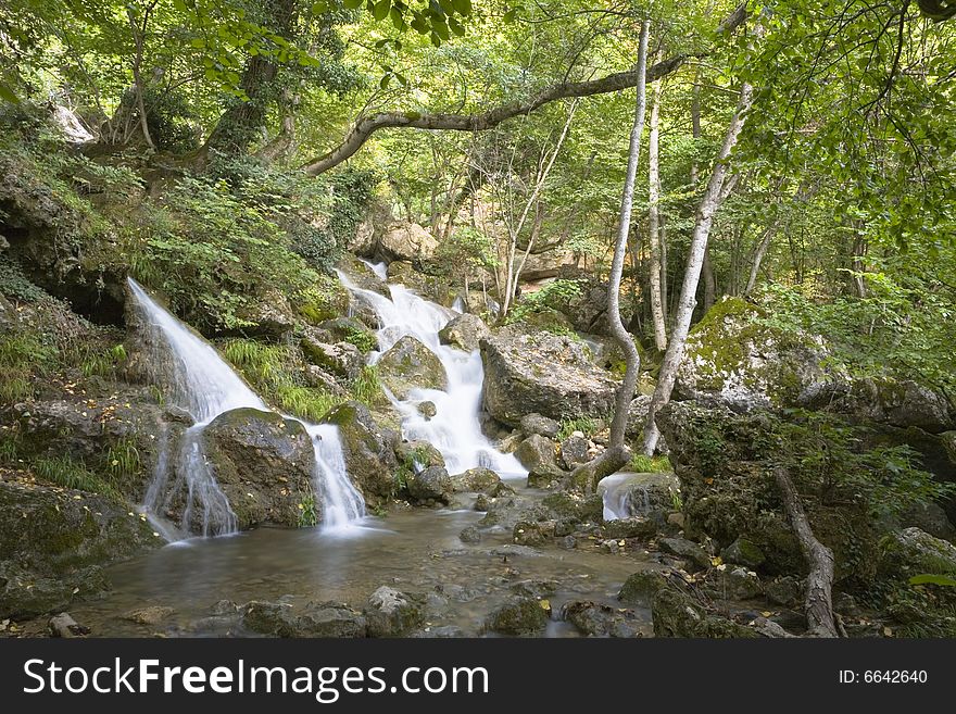 Waterfall in forest, mountain river