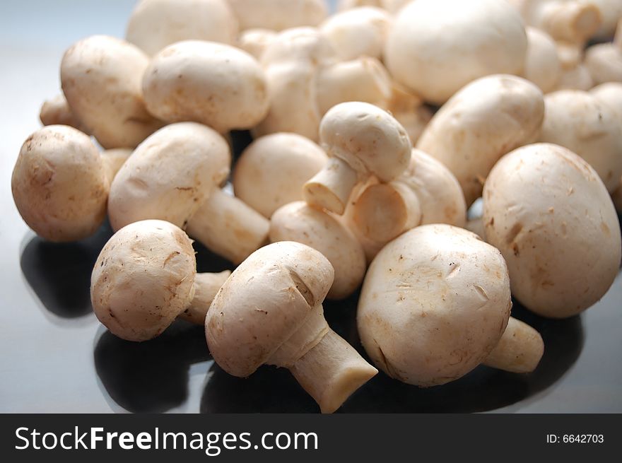 White mushrooms - champignons - on black background
