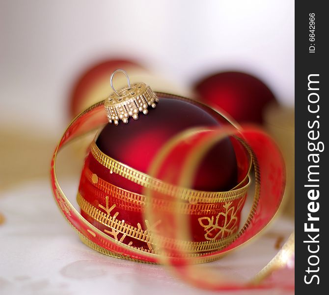 Red bauble with red ribbon; selective focus. Red bauble with red ribbon; selective focus