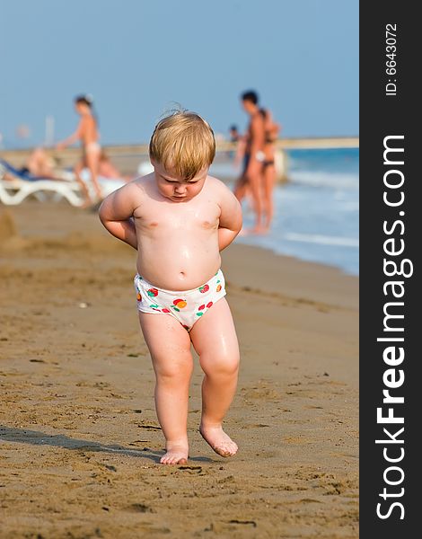 Thoughtful child goes on a sea beach