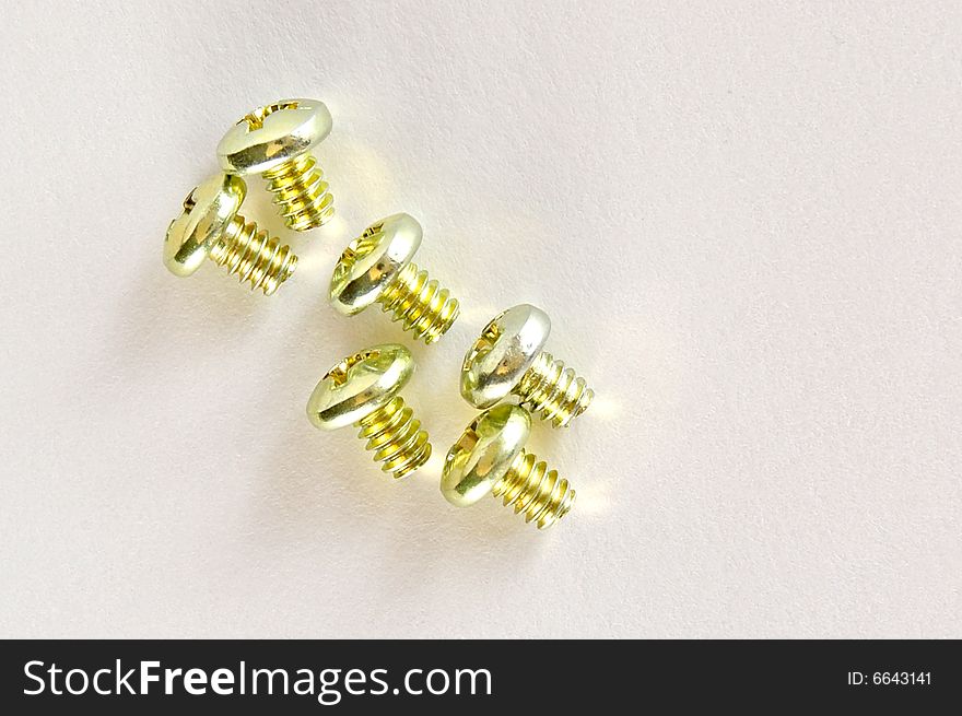 Yellow screws on a textured background