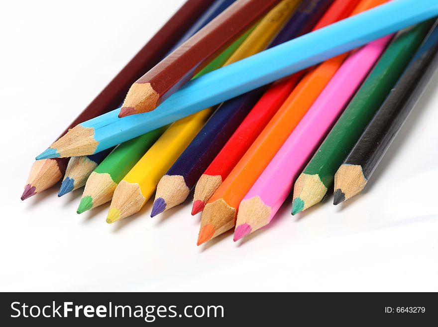 Color pencils in arrange in color wheel colors on white background