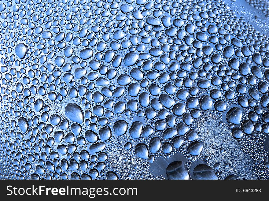 Water drops on a bottle closeup