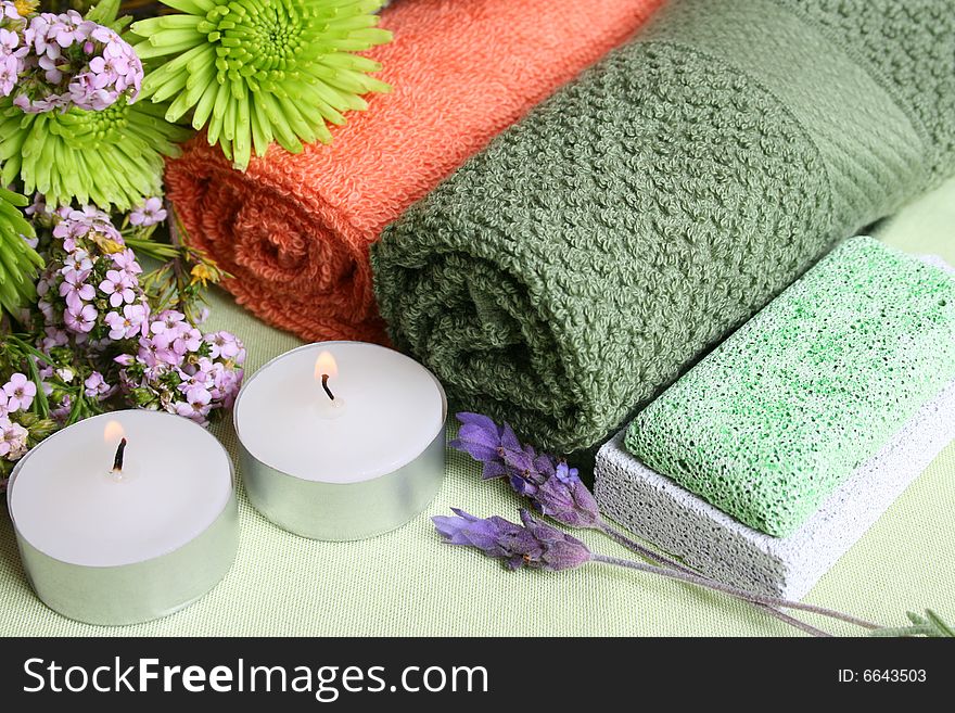 Spa Accessories setting with face cloths, candles and flowers. Spa Accessories setting with face cloths, candles and flowers