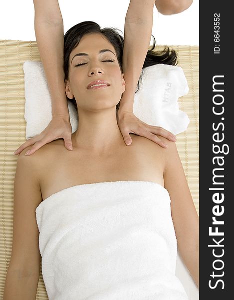 White woman receiving massage on an isolated background