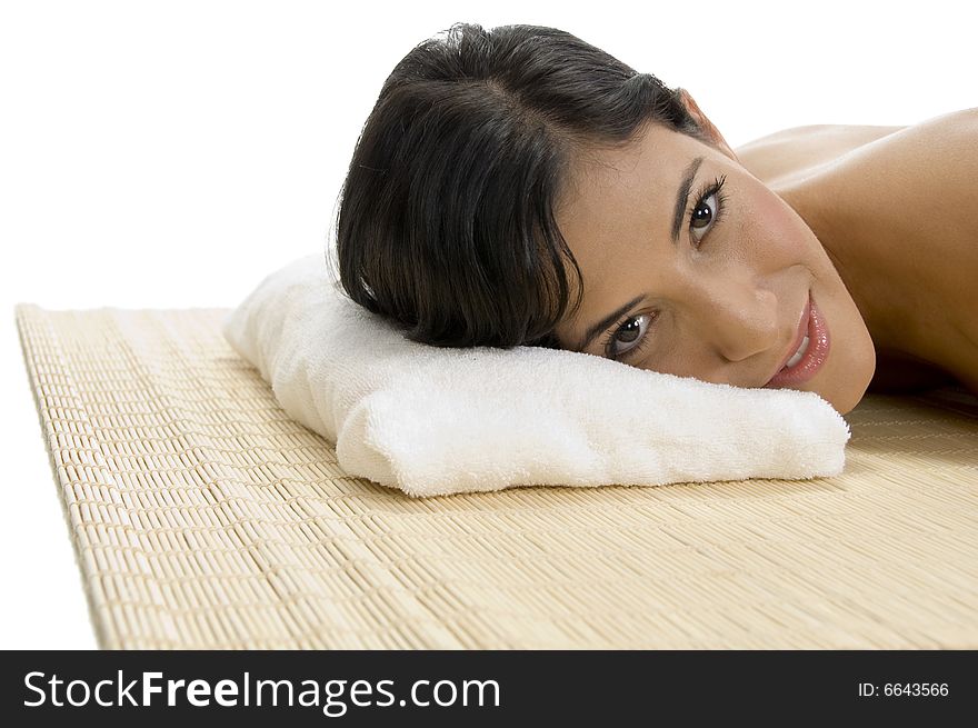 Laying woman looking to camera on an isolated background