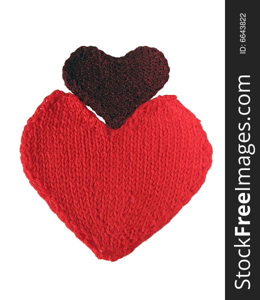 Two knitted hearts on the white background