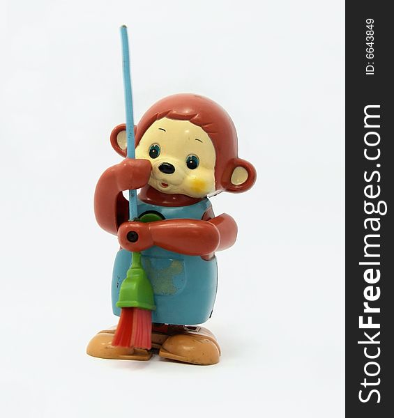 Old plastic monkey toy with broom