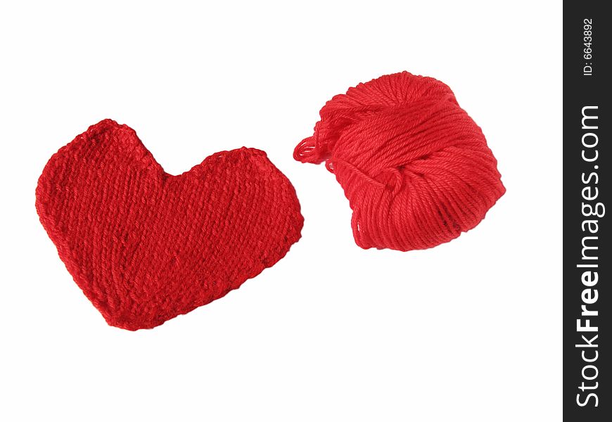 Red skein and knitted heart on white background. Red skein and knitted heart on white background