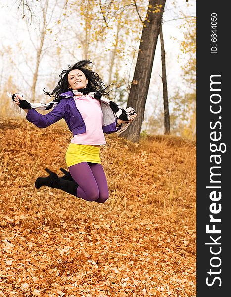 Happy smiling jumping girl in the park. Happy smiling jumping girl in the park