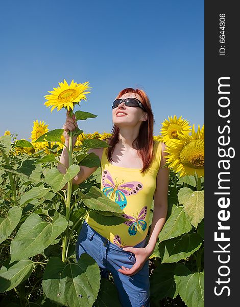 Red-hair Ukrainian Girl Holds A Sunflower