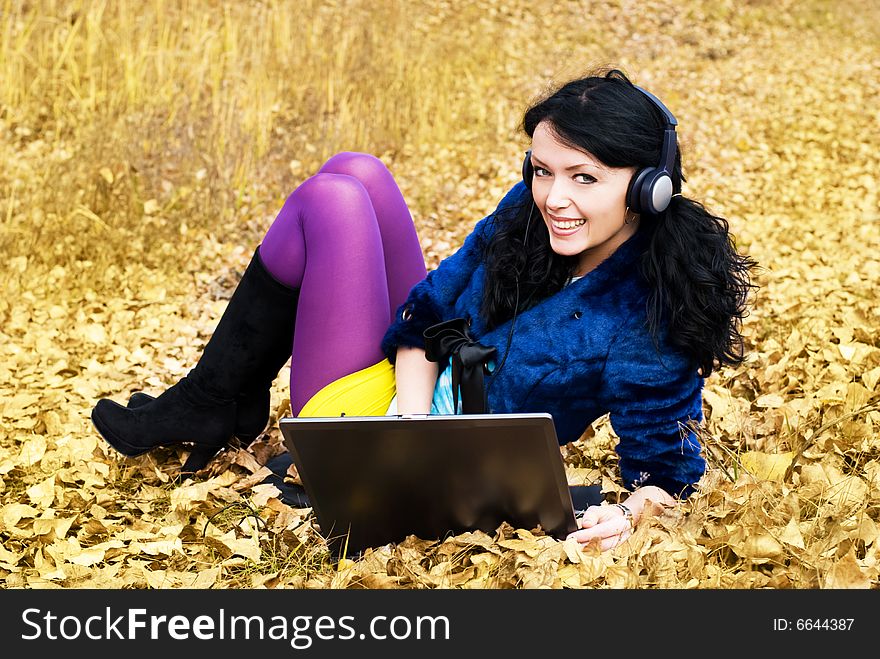 Pretty smiling girl with a laptop outdoor. Pretty smiling girl with a laptop outdoor