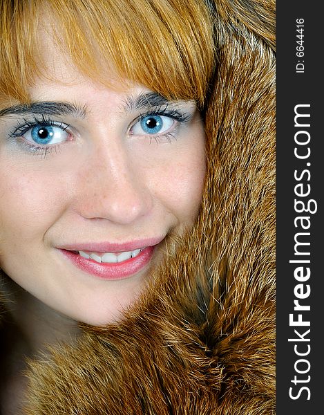 Beautiful blue-eyed woman in fox fur