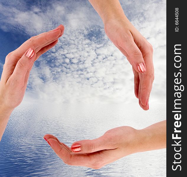 recycling symbol made from hands - sky and ocean as a background