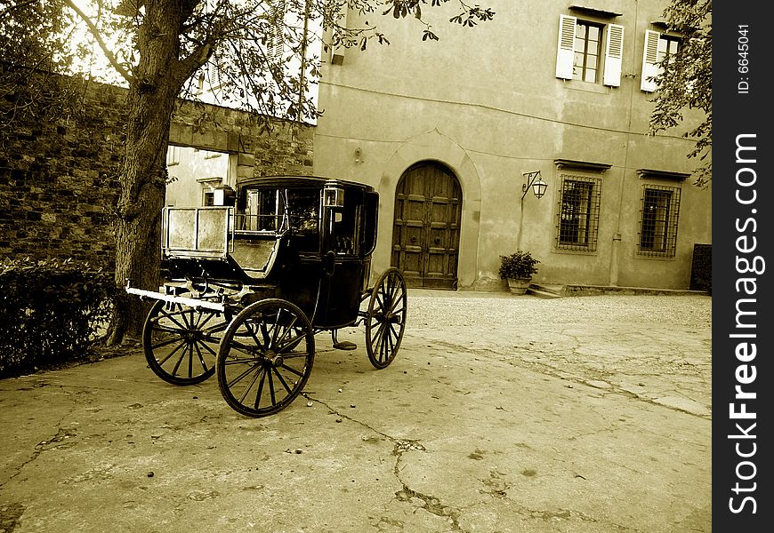 A suggestive monochrome of an old carriage in a historic house in Florence countryside