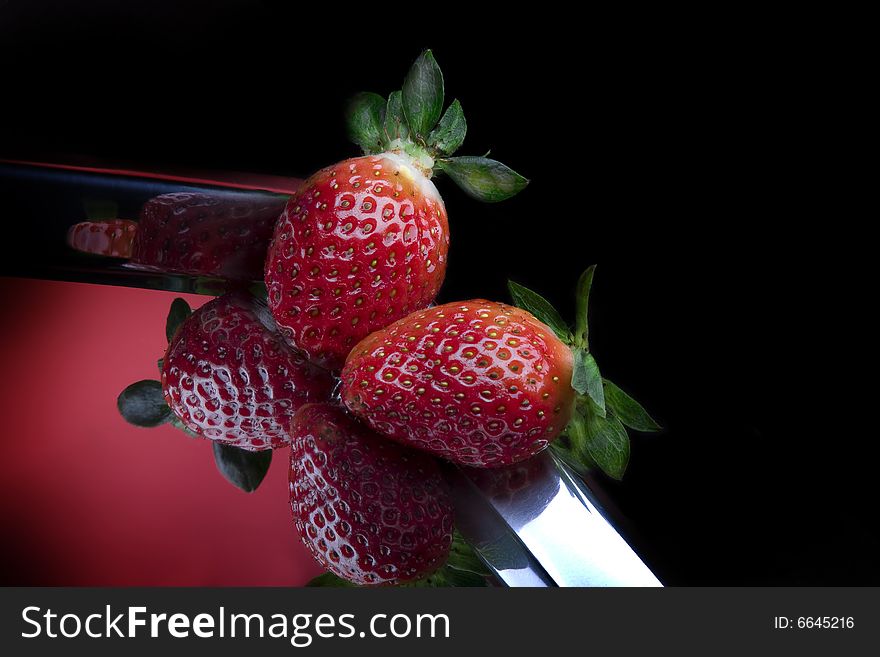 Close up view of  nice fresh strawberry on black back. Close up view of  nice fresh strawberry on black back