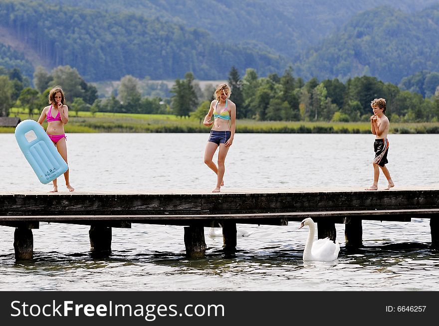 Three children at a lake. Three children at a lake