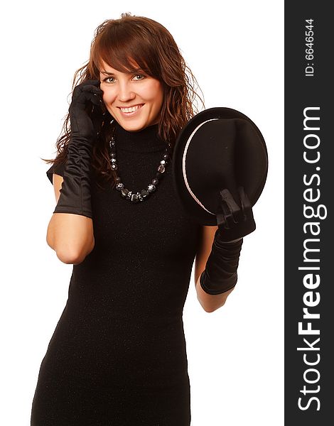 The girl in black clothes on a white background with a hat hat