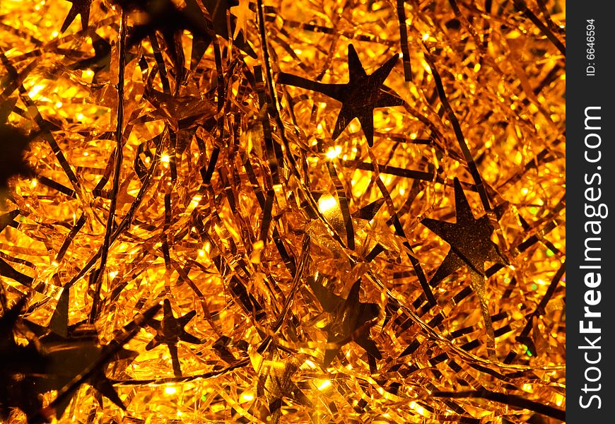 Illuminated golden Christmas tinsel background. Illuminated golden Christmas tinsel background