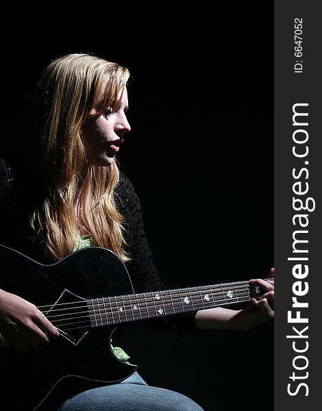 Woman Playing Guitar And Concentrating
