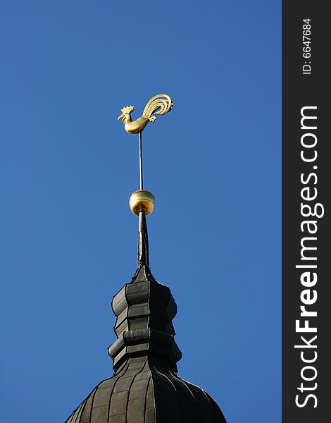 Golden weathercock - symbol of the Riga (Latvia). Golden weathercock - symbol of the Riga (Latvia)