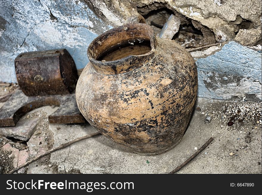 Handmade old jug, vintage against a ruinny background. Handmade old jug, vintage against a ruinny background