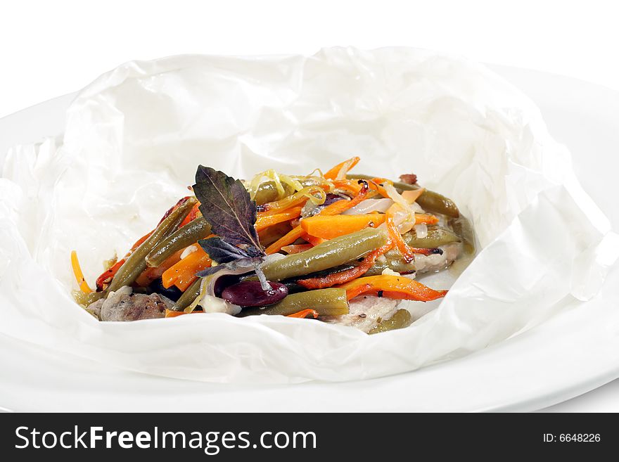 Pork and Vegetables Wrapped in Paper Served with Basil Leaves. Isolated on White Background. Pork and Vegetables Wrapped in Paper Served with Basil Leaves. Isolated on White Background