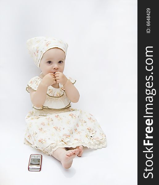 Little baby girl with cell phone, isolated on white