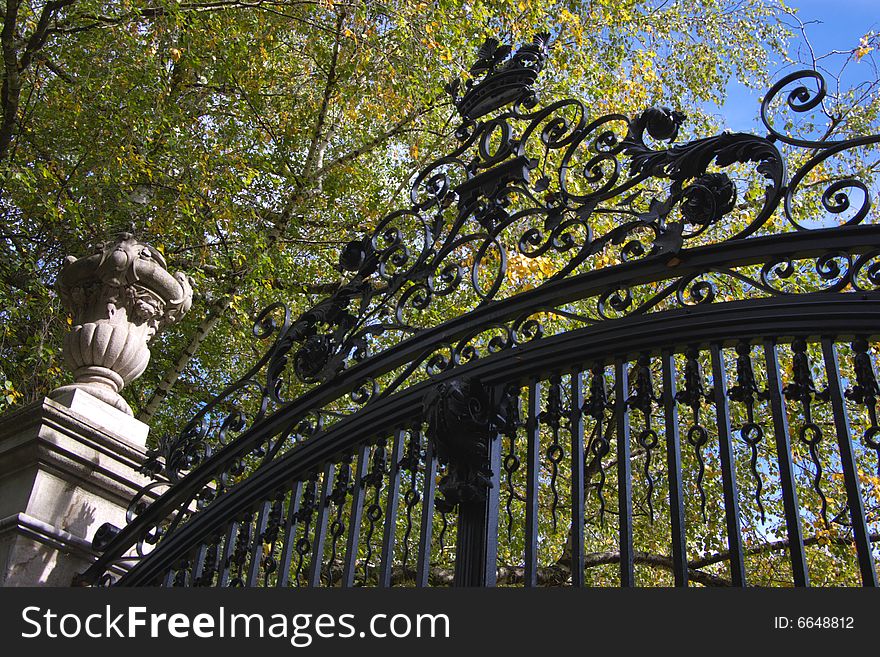 Bronze decorated fence in a park, horizontal. Bronze decorated fence in a park, horizontal.