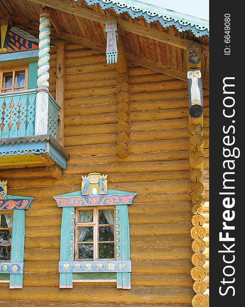 Russian style. Wooden blockhouse on the blue sky background. Russian style. Wooden blockhouse on the blue sky background.