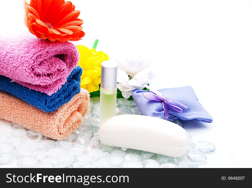 Colorful bath towels with flowers, soap and perfume. Colorful bath towels with flowers, soap and perfume