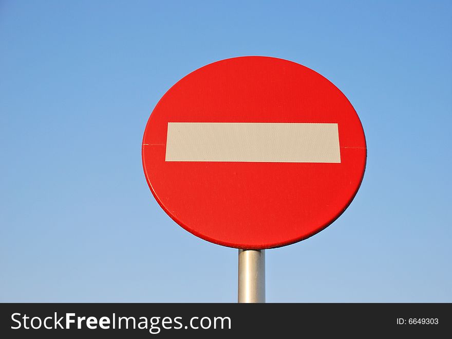 No entry sign against blue sky