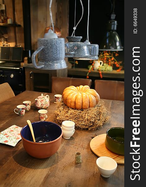 Table with pumpkin in country kitchen. Table with pumpkin in country kitchen