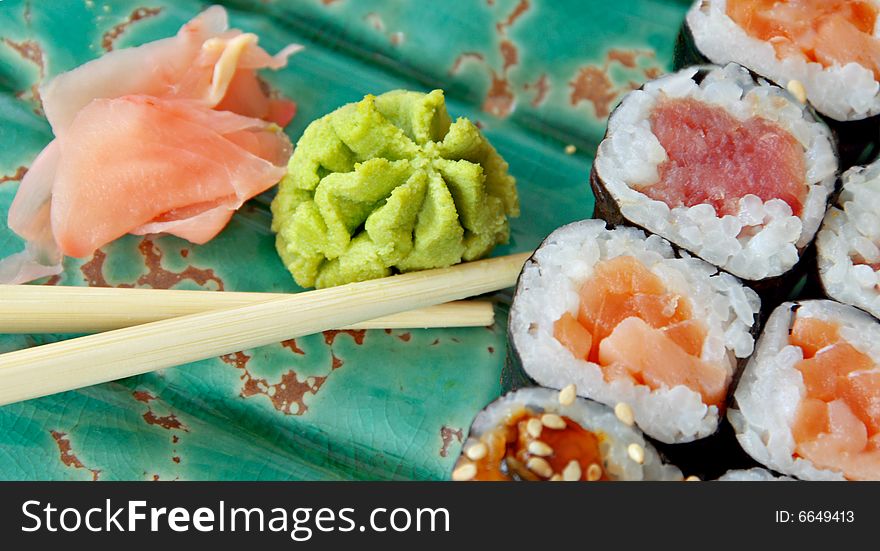 Different kinds of Sushi in on a green plate. Different kinds of Sushi in on a green plate.