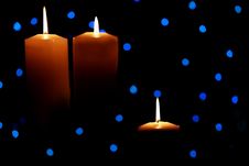 Three Large Candles Lit Amongst Blue Lights Royalty Free Stock Images Three Large Candles Lit Amongst Blue Lights Royalty Free Stock Images