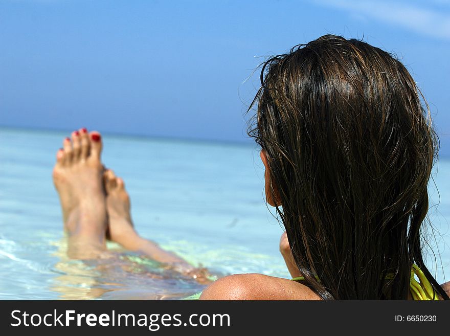 Woman lying in ocean in the caribbean sea. Woman lying in ocean in the caribbean sea