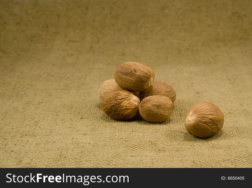 Whole nutmeg fruits on burlap