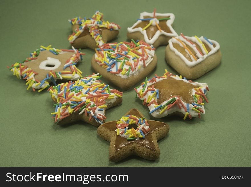 Decorated gingerbread cookies on green paper. Decorated gingerbread cookies on green paper