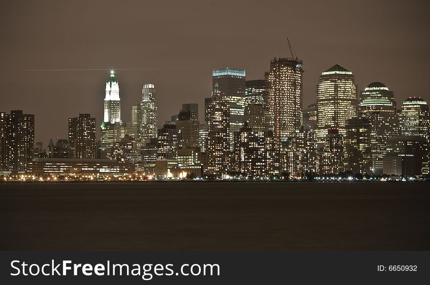 A city scape of Manhattan at night time,  this is the view from Jersey City- from across the river. A city scape of Manhattan at night time,  this is the view from Jersey City- from across the river