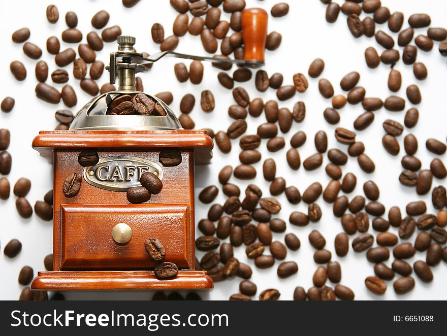 Old-fashioned coffee grinder with coffee beans