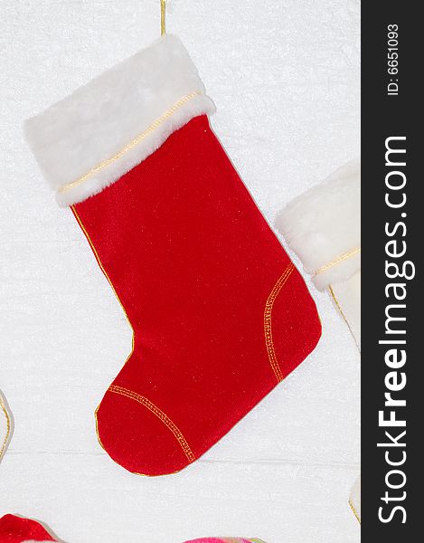 Red sock hanging on white wall