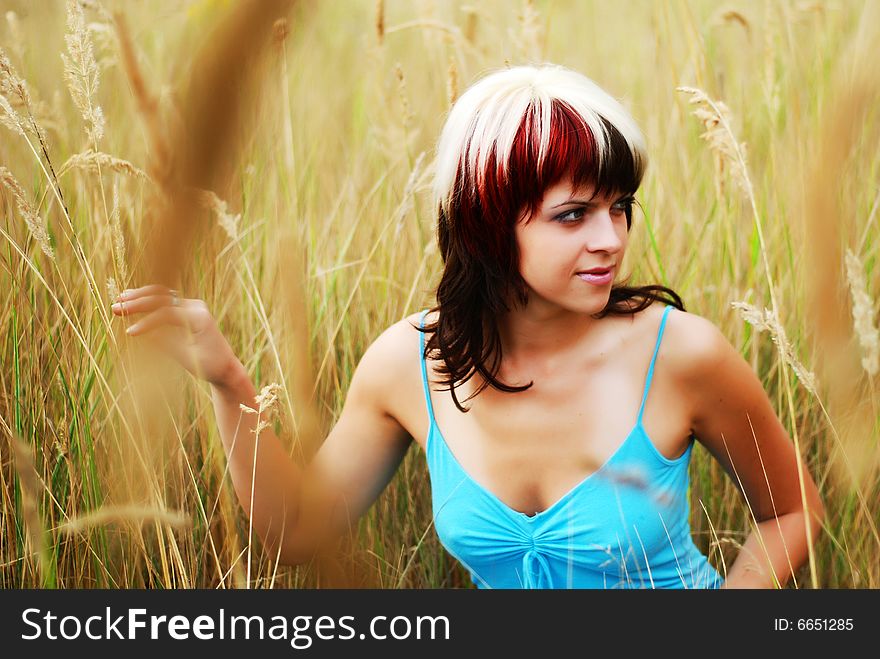 Beautiful young woman in tne dry grass. Beautiful young woman in tne dry grass