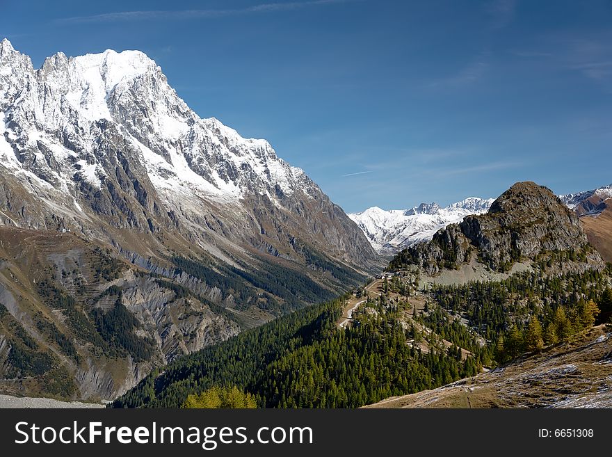 Summer view of snowcapped peaks in an alpine valley. Gran Jourasses (Mont Blanc massif), Val Veny, Courmayeur, Italy. Summer view of snowcapped peaks in an alpine valley. Gran Jourasses (Mont Blanc massif), Val Veny, Courmayeur, Italy.