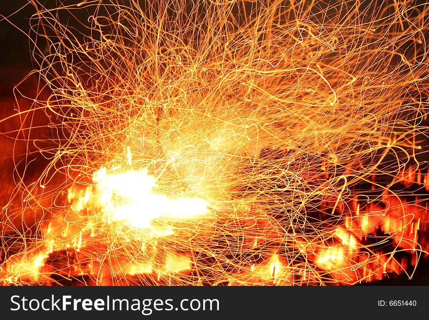 The sparks of a campfire captures by a slower shutter speed. The sparks of a campfire captures by a slower shutter speed.