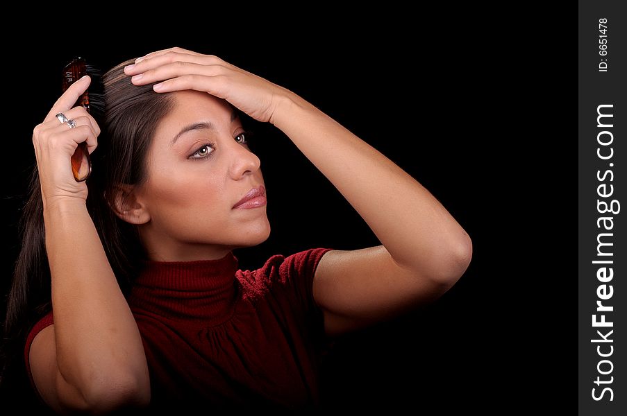 Beautiful image of a brunette woman Brushing her hair