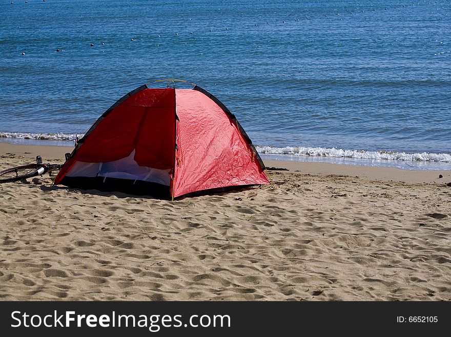 A tent by the sea on a sandy beach. A tent by the sea on a sandy beach